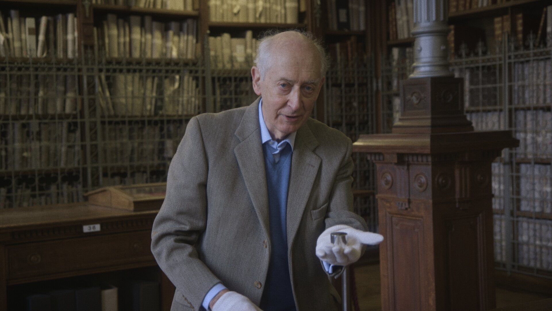 Beyond Measure — still, archivist with white gloves